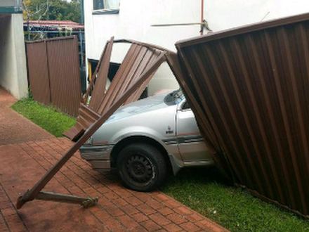 Brown Colorbond panels blown down onto a parked silver car