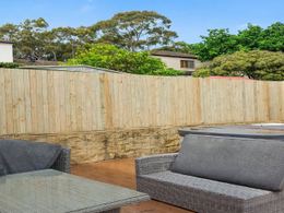 Treated pine paling fence behind a spa