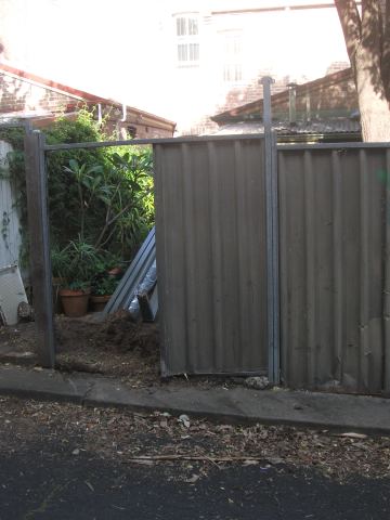 Colorbond posts and one panel in place with the street bay still open