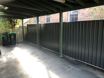 Charcoal Colorbond privacy fence closing the back of an open carport