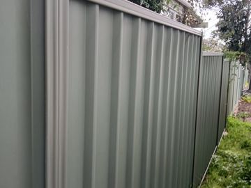 Close view of mid grey Colorbond privacy sheets and a corner post