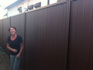 Close view of bronze Colorbond privacy sheets showing the corrugated profile