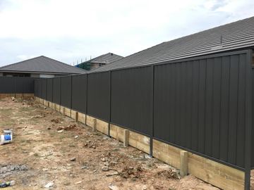 Charcoal Colorbond privacy fence on a timber sleeper at a new house