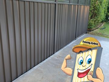 Close view of a mid grey Colorbond privacy fence standing on a concrete pad