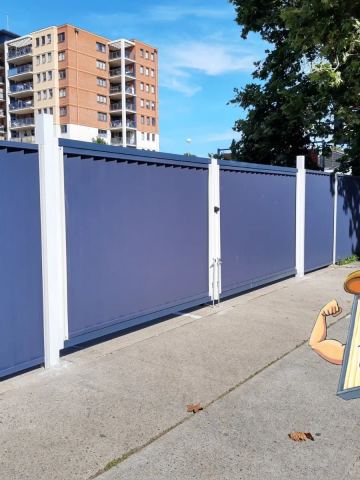 Installed Colorbond sheets forming a privacy boundary with a matching gate opening.