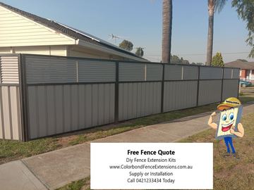 Grey Colorbond privacy fence with a matching slat height extension along a street