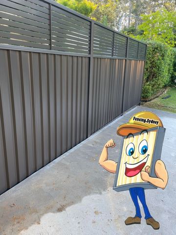 Grey Colorbond privacy fence along a concrete path