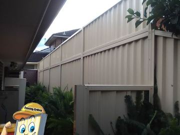 Cream Colorbond privacy fence seen from under a patio roof