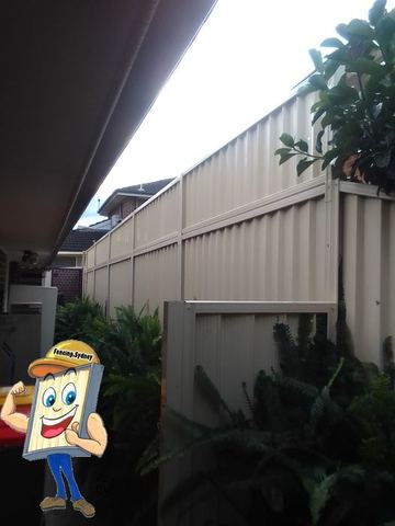 Cream Colorbond privacy fence seen from under a patio roof