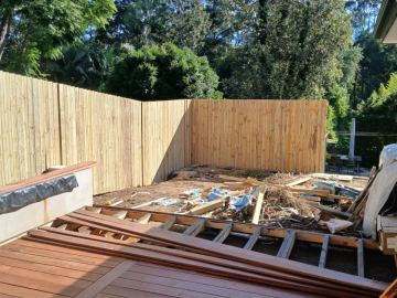 New treated pine paling fence enclosing a deck under construction