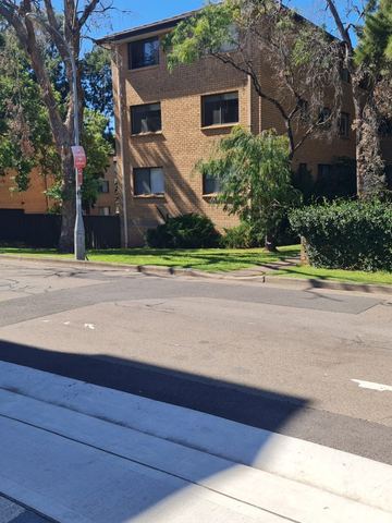 Residential street and apartment building before boundary fence work