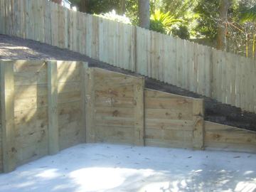 New treated pine paling fence enclosing an empty pool excavation