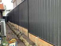 Black Colorbond fence on a timber plinth