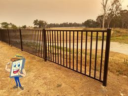 Black flat top pool fence along an open yard