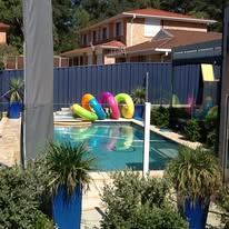 Blue Colorbond fence screening a swimming pool