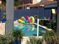 Blue Colorbond fence screening a swimming pool
