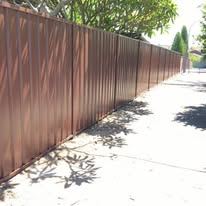 Brown Colorbond fence along a footpath