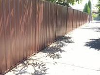 Brown Colorbond fence along a footpath