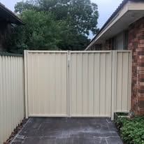 Cream Colorbond double gate across a driveway