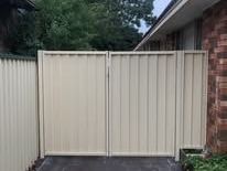 Cream Colorbond double gate across a driveway
