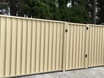 Cream Colorbond double gate at a commercial entry