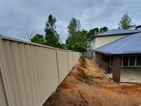 Cream Colorbond fence along a backyard