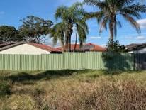 Cream Colorbond fence replacing an old green run