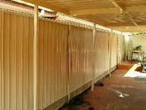 Cream Colorbond fence under a patio roof