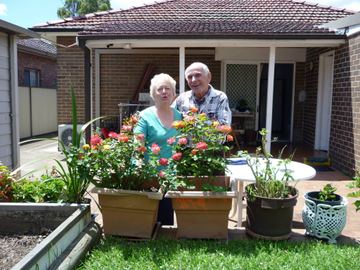 Customers on the patio in front of a new Colorbond fence