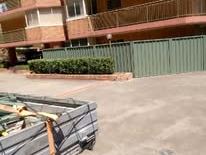 Green Colorbond fence in front of a unit block