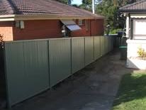 Grey Colorbond boundary fence down the side of a house