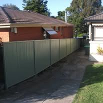 Grey Colorbond boundary fence down the side of a house