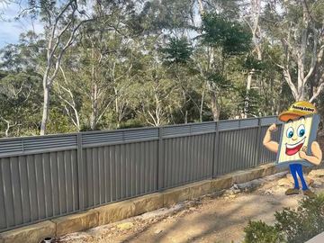 Grey Colorbond fence along a bush block