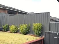 Grey Colorbond fence along a newly turfed yard