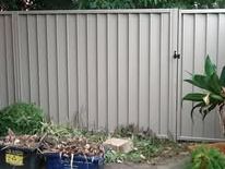 Grey Colorbond fence and gate in a side yard