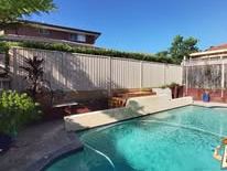 Grey Colorbond fence enclosing a swimming pool