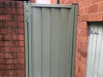 Grey Colorbond pedestrian gate in a brick wall
