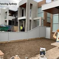 Light grey Colorbond fence in front of townhouses