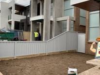 Light grey Colorbond fence in front of townhouses