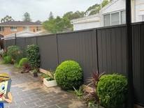 Monument Colorbond fence along a paved side path