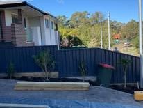 Monument Colorbond fence behind a new concrete slab
