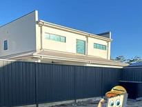 Monument Colorbond fence in front of a two-storey house