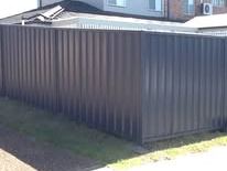 Monument Colorbond fence returning along a lawn