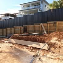 Monument Colorbond fence with the old timber panels still on site