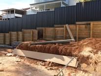 Monument Colorbond fence with the old timber panels still on site