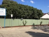 Pale green Colorbond fence along a street