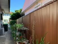 Woodland grey Colorbond fence down a planted side path