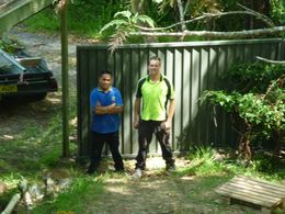 Woodland grey Colorbond fence with the installers beside it