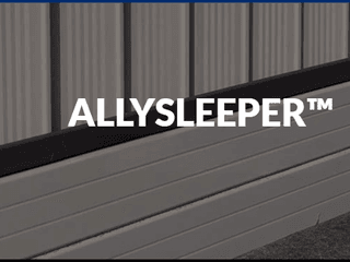 Colorbond sheets sitting above an aluminium sleeper retaining wall