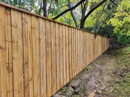 Lapped and capped timber paling fence